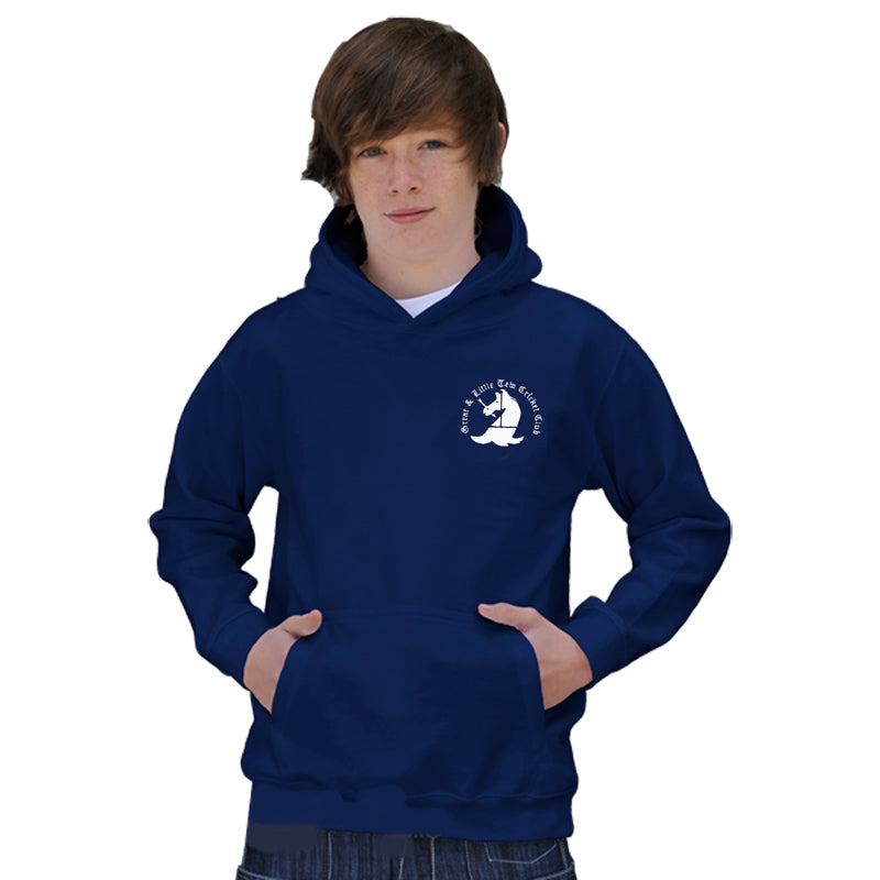 A teen boy with brown hair models the Martin Berrill Sports Great Tew CC Junior Navy Hoody, featuring a white chest graphic and kangaroo pocket. Made from soft cotton-faced fabric, he stands with hands in the front pocket against a plain white background.