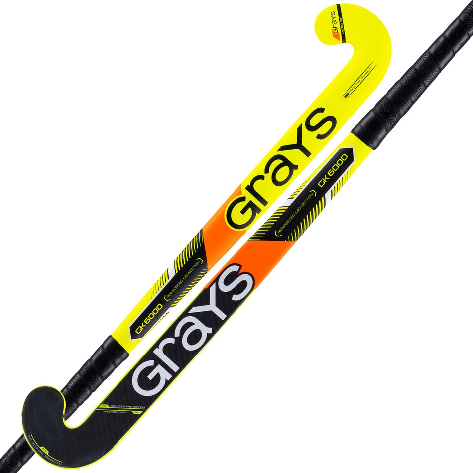 Two Grays GK6000 Pro Goalie Hockey Sticks, with a yellow and orange gradient design, black accents, large white "Grays" branding, black grip tape handles, and an ultrahigh balance point for exceptional control.