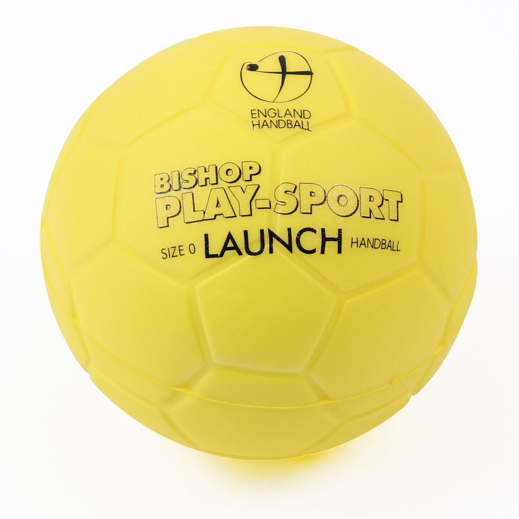 A yellow Mastersport Launch Handball from England Handball (Set of 4) with black text and the England Handball logo on a hexagonal surface. This Size 0 PU foam starter ball is approved by the England Handball Association.