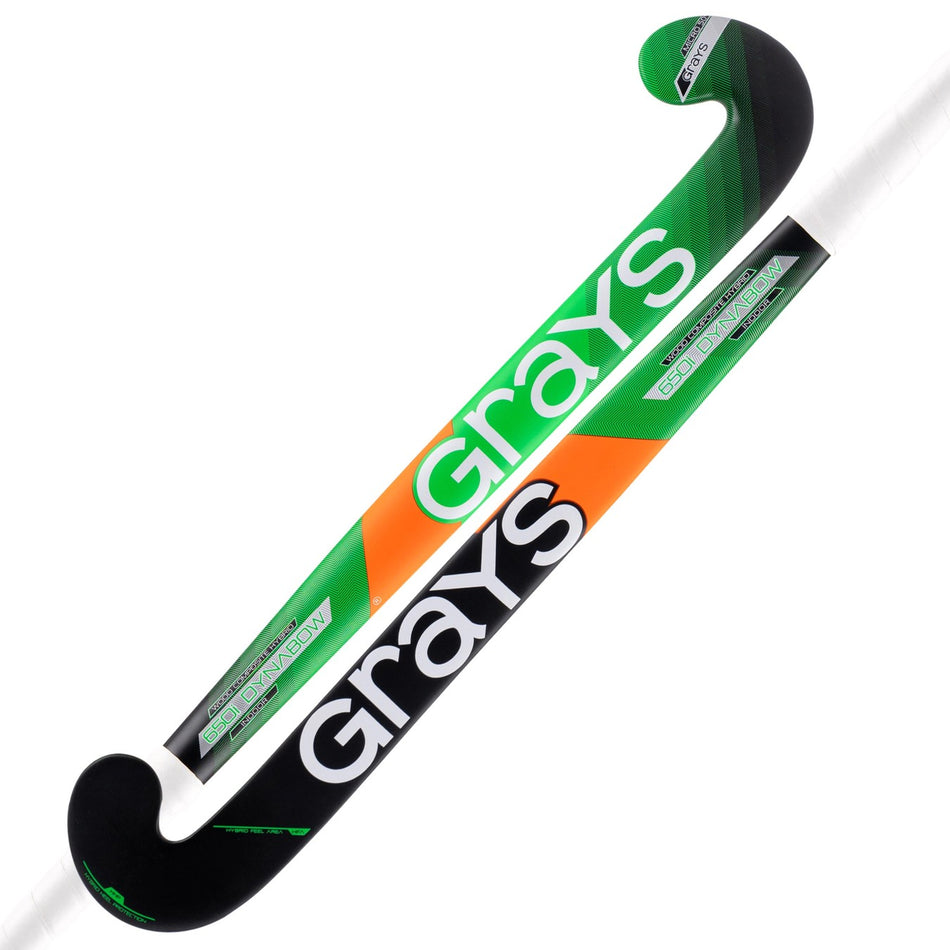 Two Grays 650i Jumbow Indoor Wooden Hockey Sticks are shown. Each features a black base with green, white, and orange accents, and has a Jumbow blade for enhanced control and powerful drag flicking.