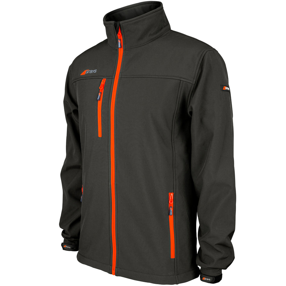 The Grays Radius Junior Soft Shell Jacket by Grays is black with bright orange zippers and small orange logo accents. Water resistant, it features a high collar, chest pocket, side pockets, and adjustable sleeves for comfort and style.
