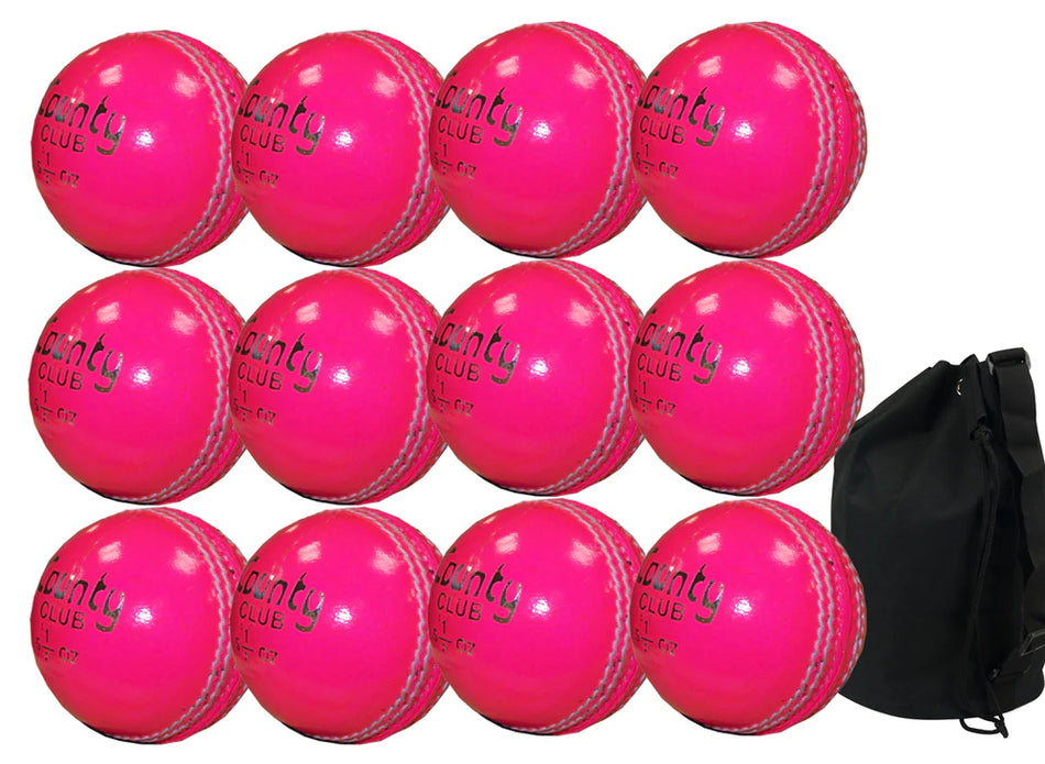 Twelve pink Hunts County Club training cricket balls are arranged in three rows beside a black Hunts County ball bag, shown on a white background.