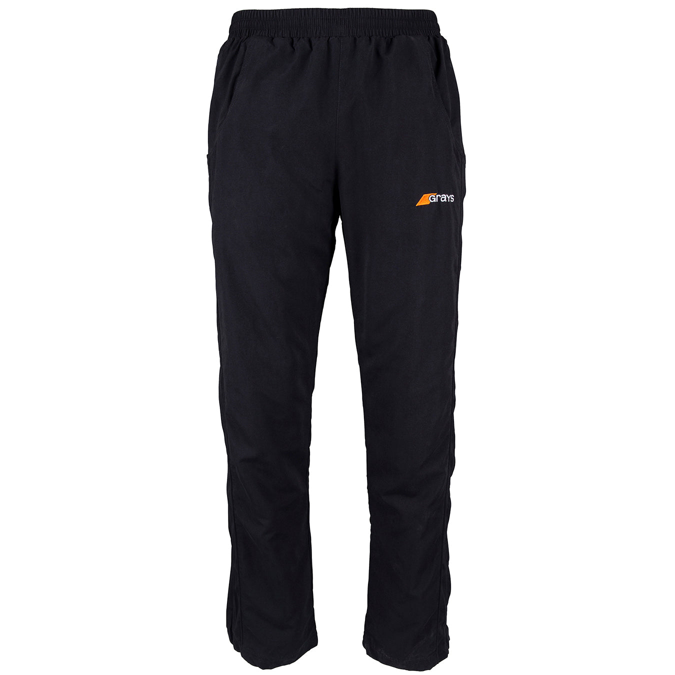 Grays Junior Glide Trousers in black feature an elastic waistband, side pockets, a small orange and white Grays logo on the left thigh, and a long leg zipper for easy wear. Shown against a plain white background.