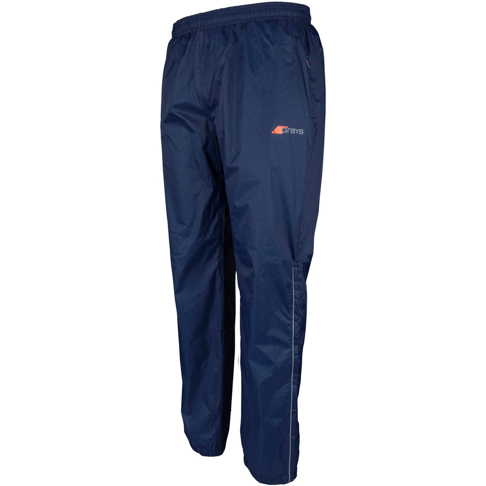 Grays Ladies ARC Rain Trousers by Grays: navy blue lightweight waterproof track pants with an elastic waistband, reflective piping, and a small orange and grey logo on the upper left thigh—perfect for outdoor or sports activities.