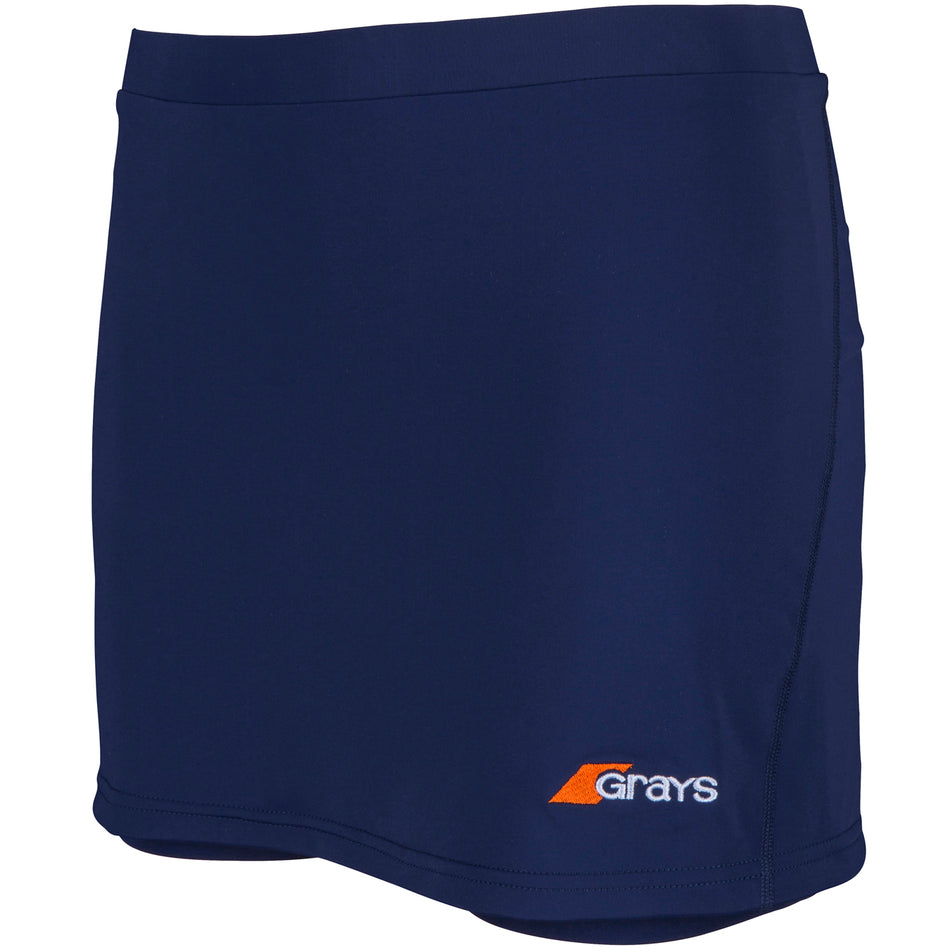 The Grays Apex Hockey Skort is a navy women’s athletic skort with stretch fabric, an elastic waistband for comfort, and a small orange and white Grays logo near the hem.