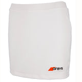 The Grays Apex Hockey Skort is a plain white women's athletic skort with an elastic waistband and a small orange and black Grays logo on the bottom right front.
