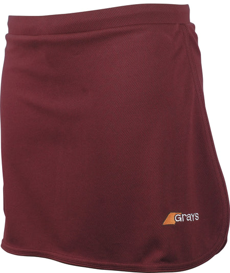 The Grays G600 Skort is a maroon women's sports skirt made from stretch lycra fabric, featuring a subtle mesh texture and a small white and yellow Grays logo near the bottom right hem for comfort and style.