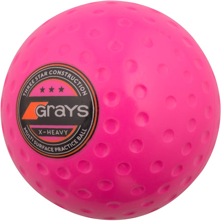 The Grays X-Heavy Hockey Ball is a bright pink, dimpled, heavy practice ball featuring the black and orange Grays logo and "X-Heavy" text—perfect for boosting dribbling and passing strength on any surface.