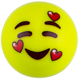A yellow emoji face with smiling eyes, raised eyebrows, and three red hearts—expressing joy and love, just like the Grays Emoji Hockey Balls (2021) from Martin Berrill Sports.
