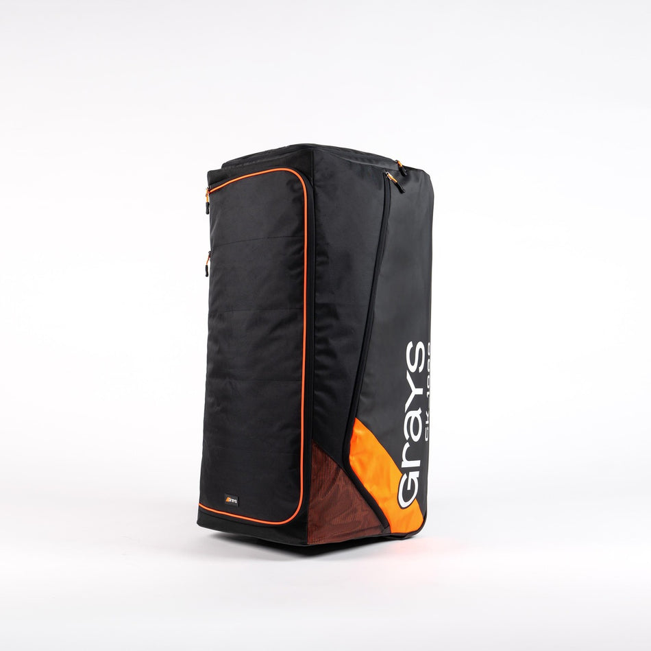The Grays GK1000 Goalie Holdall is a large black rectangular wheelie bag with orange accents, zippered top, and Grays branding—perfect for goalkeepers or large storage—shown upright against a white background.