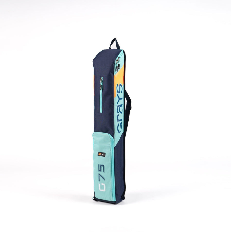 The Grays G75 Stickbag by Grays, shown upright on a white background, features navy blue and teal water-repellent fabric, a zippered storage pocket, and a shoulder strap.