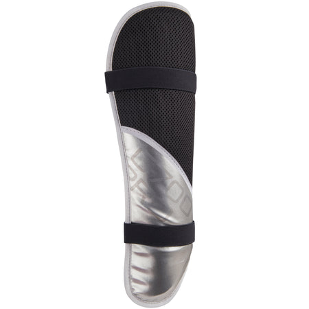 The Grays G700 Pro Shinguards by Grays feature a black and silver design with two black securing straps, mesh fabric on the upper part, and a sculpted hard shiny silver shell on the lower part.