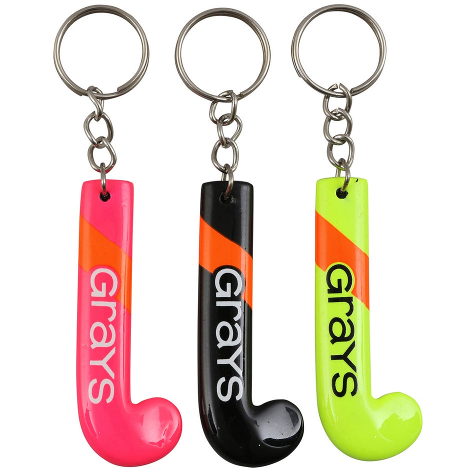The Grays Stick Key Ring (Pack of 12) features mini hockey stick keychains in pink, black, and yellow-green, each with "Grays" vertically and silver key rings—ideal as assorted souvenir gifts.