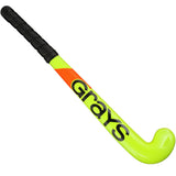 The Grays Replica 18 inch Hockey Stick features a bright yellow design with a black handle grip, bold "Grays" branding along the shaft, and an orange accent near the handle for standout style on the field.