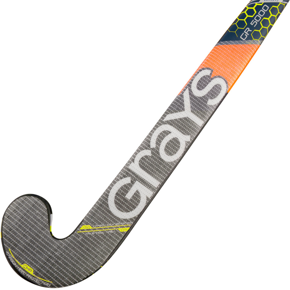 The Grays Pro Guard field hockey stick features a grey, yellow, and orange design, fibreglass reinforced construction, and displays the Grays brand name in large white letters along the shaft.