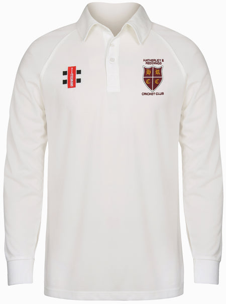 The Gray Nicolls Hatherley & Reddings CC Matrix V2 Long Sleeve Shirt in white has a collared, buttoned design, plus two chest badges: a red, black, and white rectangle and the Hatherley & Reddings Cricket Club crest.
