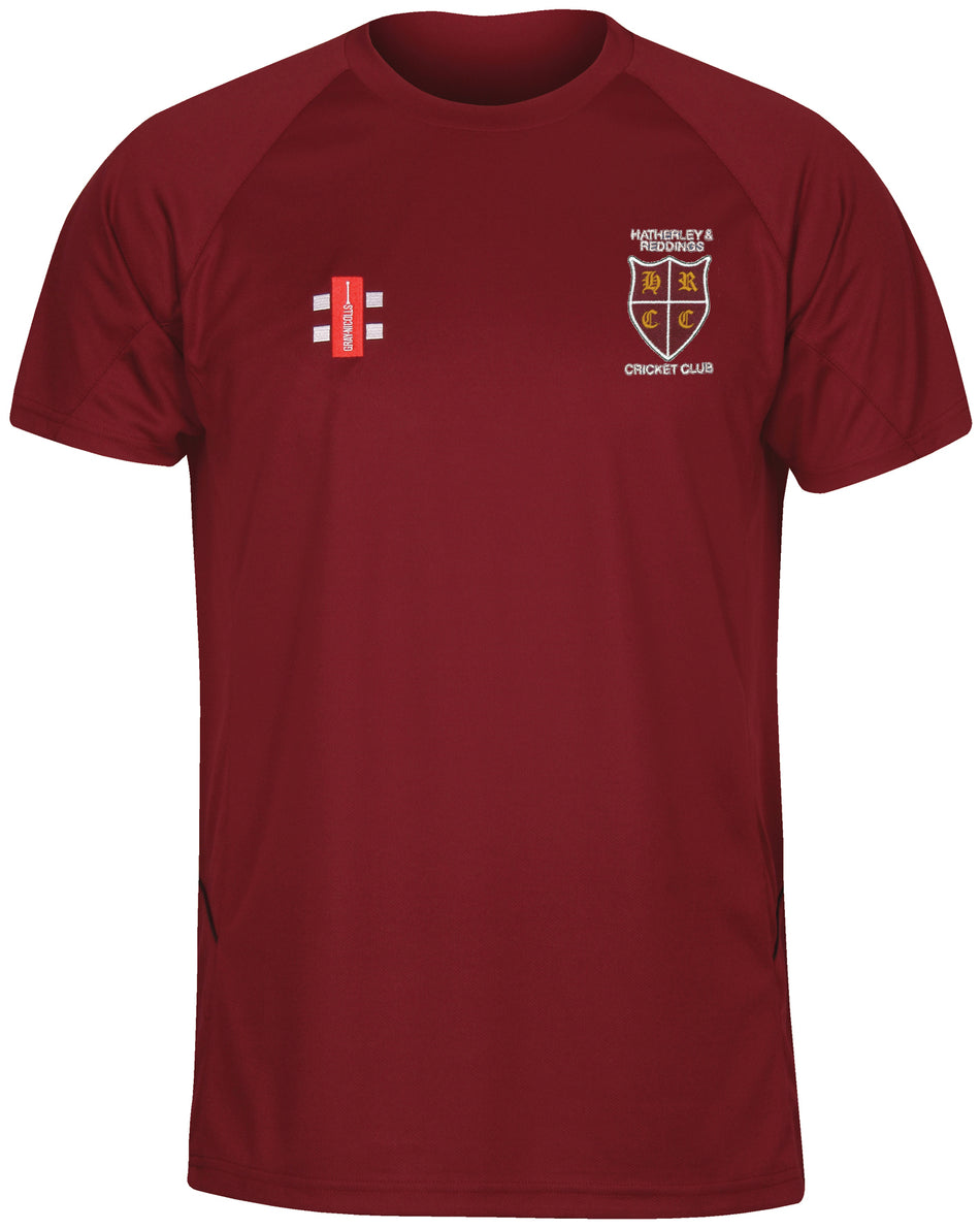 The Gray Nicolls Hatherley & Reddings CC Junior Matrix V2 T Shirt features moisture-wicking fabric, a small cricket emblem and club text on the left chest, plus a red-and-white cricket stumps logo on the right chest.