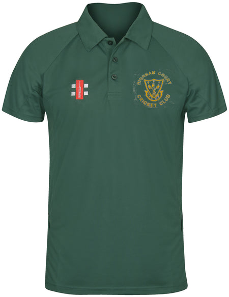 The Gray Nicolls Highnam Court CC Matrix V2 Polo Shirt is dark green with the club’s yellow logo and crest on the left chest, moisture wicking fabric for training, and a small red patch with white lines on the right chest.