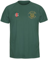 The Gray Nicolls Highnam Court CC Matrix V2 Tee Shirt is a green, moisture-wicking polyester cricket shirt with short sleeves and a round neck, featuring an embroidered Highnam Court CC logo on the left chest and a red-and-white badge on the right.
