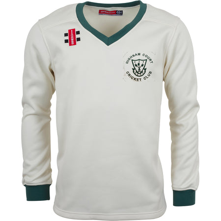 The Gray Nicolls Highnam Court CC Pro Performance Sweater is cream with green cuffs and a V-neck, made from sport-specific fabric. It features the club logo on the left chest and a red patch on the right shoulder.