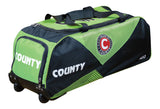 The Hunts County Neo Wheelie Cricket Bag in black/green has COUNTY on the side, a circular Hunts County logo, sturdy top handles, wheels, and multiple zip compartments for organized cricket gear storage.