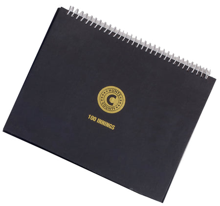 The Hunts County 100 Innings Scorebook is a black wire-bound scorebook featuring a gold "COUNTY HUNT" emblem and "100 INNINGS" below, perfect for recording school club matches.