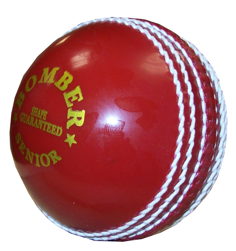 The Hunts County Bomber Ball by Hunts County is a shiny red cricket training ball with white stitching and "BOMBER SENIOR SHAPE GUARANTEED" in yellow text, ideal for power practice and skill sessions.