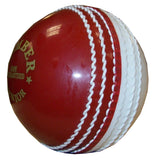 A close-up of the Hunts County Bomber Ball by Hunts County in red/white, featuring prominent stitching and part of a gold logo—an ideal choice for cricket training.