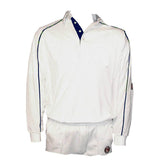 The Siddington CC Active Long Sleeve Cricket Shirt by Martin Berrill Sports features blue trim and sleeve logo patches. Made from active wick-away material for cool comfort, it’s shown with matching shorts on a plain background.