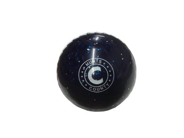 The Hunts County Glitter Ball, a dark blue glossy cricket ball by Hunts County, features a white star-surrounded C logo and is shown on a plain white background. Designed as a soft PVC training ball, it's ideal for practice sessions.