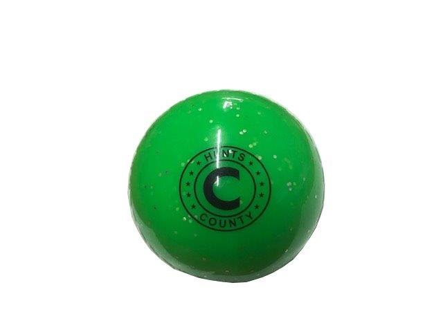 The Hunts County Glitter Ball is a shiny green training ball with black speckles, featuring "COUNTY HUNTS" and a bold letter C in black within a circular emblem, perfect as a soft training ball.