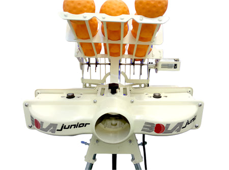 A close-up of the Bola BOLA Junior Bowling Machine, with racks holding several orange balls above its two launching wheels.