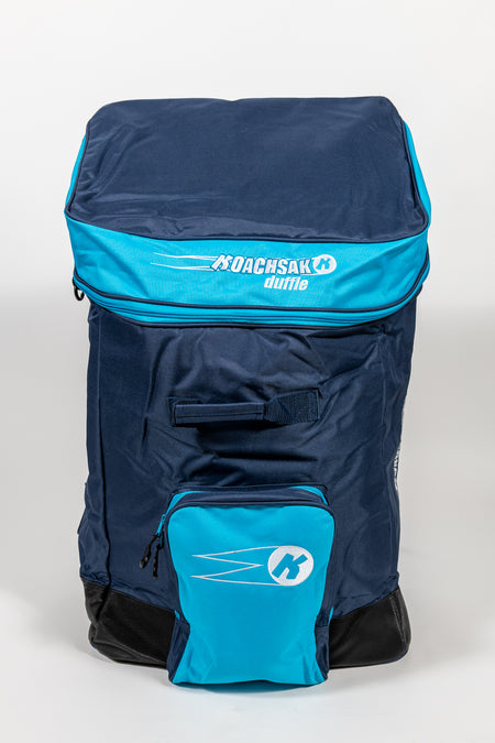 The Katchet KoachSak Duffle is a spacious navy and bright blue bag with the Katchet logo on the top flap, rucksack-style handles, zippered front pocket, and water-resistant material, shown upright against a plain white background.