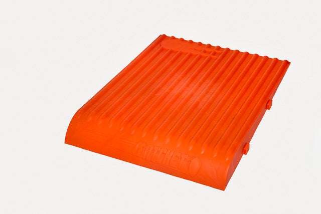 A bright orange, rectangular plastic Katchet Training Aid by Katchet with a ridged surface and raised edges lies flat on a white background. Ideal for cricket training and catching practice.