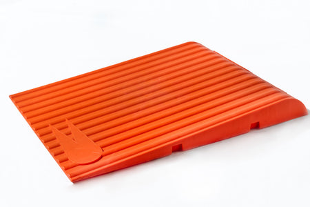 The Katchet Training Aid by Katchet is an orange, rectangular, ribbed plastic ramp with a slight incline and a raised rabbit logo—perfect as a fielding aid for catching drills in cricket training.