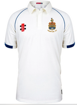 The Kempton CC Matrix V2 Short Sleeve Match Shirt by Gray Nicolls is white with blue trim, a collar, Kempton CC’s embroidered left chest crest, and sponsor logos on both sides of the chest.