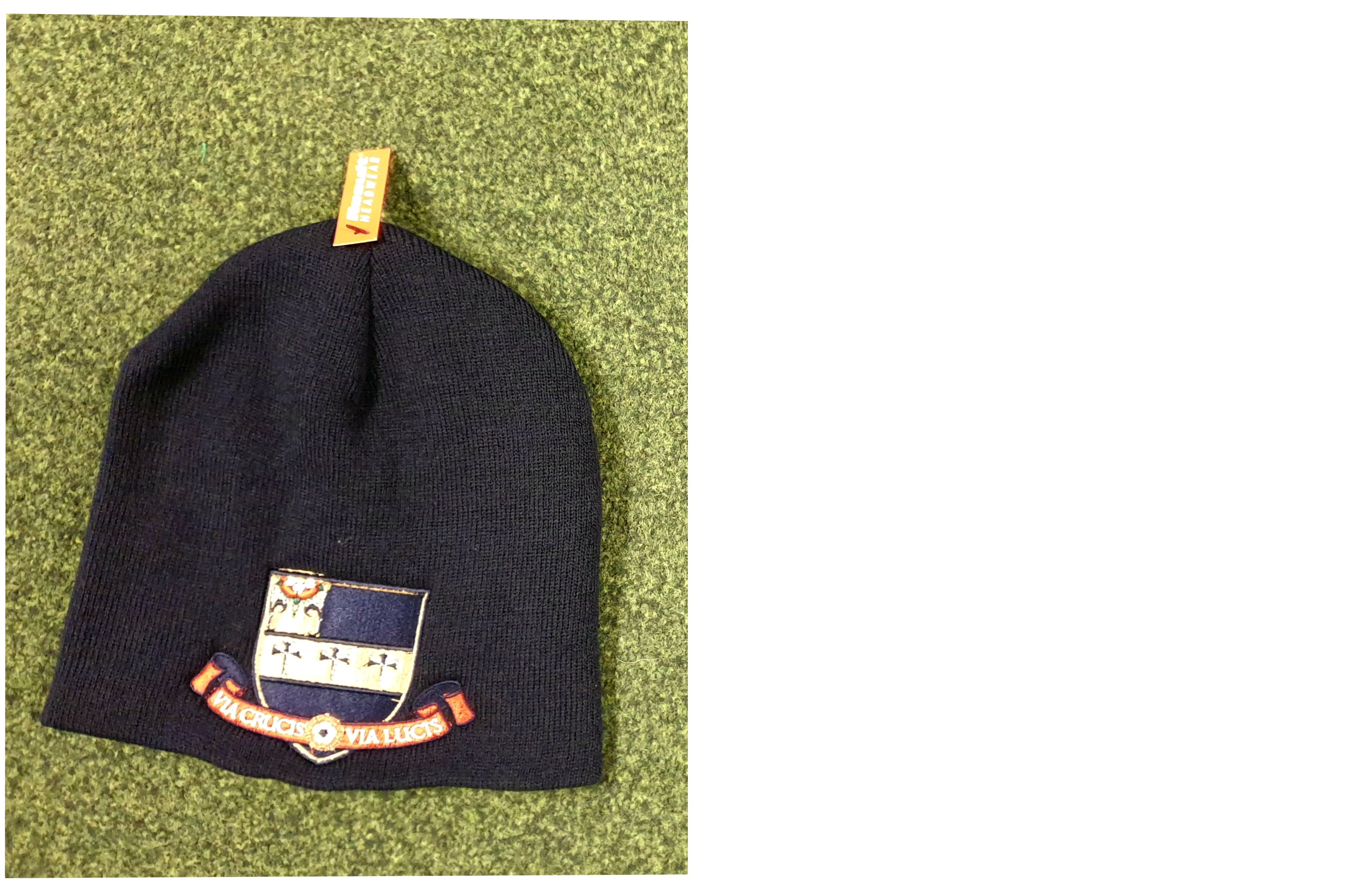 A black Kings School Beanie Hat by Martin Berrill Sports, featuring a crest and Latin motto on a banner, sits on a green textured surface. An orange “VIMMA” tag is attached—this cozy, one-size hat shows school spirit in style.