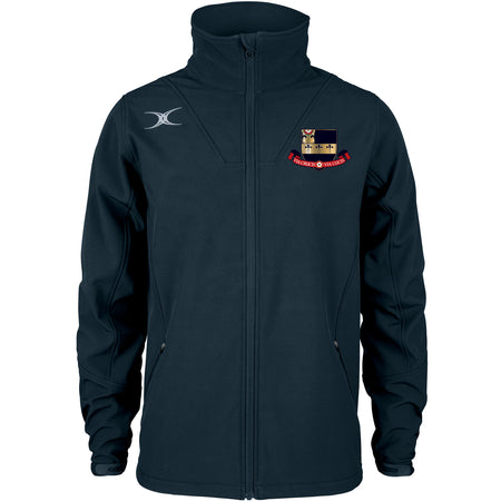 The Gilbert Kings School Pro Soft Shell Full Zip Jacket is navy blue with long sleeves, a silver logo on the right chest, a colorful crest with banner on the left, two zippered pockets, a high collar, and is made from breathable fabric.