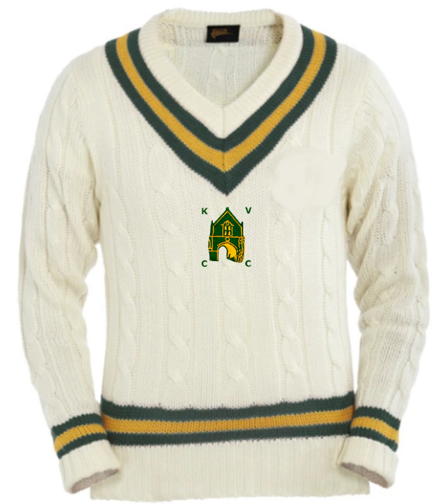 The Martin Berrill Sports Kingswood Village CC Cricket Sweater features cream cable knit with green and gold stripes on the collar, cuffs, and hem, plus the KVCC embroidered crest with club logo on the chest.