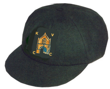 The Kingswood Village CC Traditional Cap by Martin Berrill Sports is bottle green and has an embroidered club badge with a yellow and blue building framed by the letters K, V, C, and C on the front.