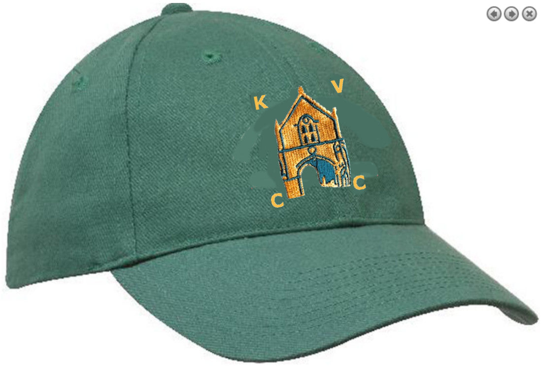 The Kingswood Village CC Green Baseball Cap by Martin Berrill Sports features an embroidered yellow-orange church archway with the club logo—K, V, and two Cs—surrounding the building on the front.