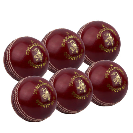 Six Kookaburra County Club Red cricket balls with white stitching and gold branding are neatly arranged in two rows on a white background.