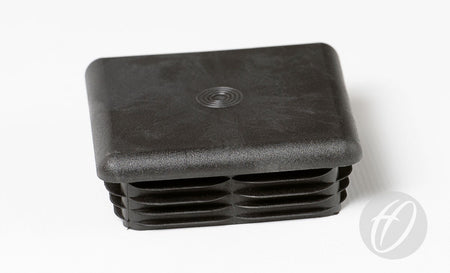 The Harrod Sport Plastic Lids for 76mm square sockets are black, square end caps with a textured top and ridged sides—ideal as drop-in socket lids for football posts.