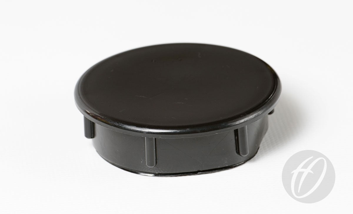 The Harrod Sport Plastic Lids for 76mm Round Sockets are black, round plastic caps with short vertical ridges, commonly used as socket lids for sports field goals.