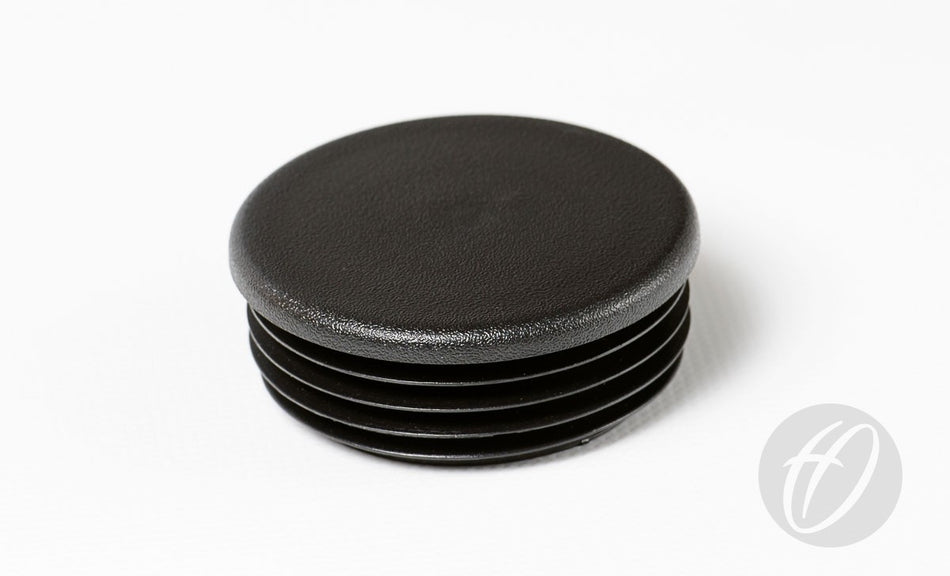 A Harrod Sport Plastic Lid for 60mm round sockets, made of black ribbed plastic and typically used for football post sockets, is shown on a white surface. A grey circular Harrod Sport logo appears at the bottom right.
