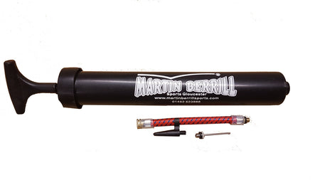 A Martin Berrill Sports Ball Hand Pump in black is shown on a white background, with a red and silver flexible inflation tube and two small metal needle adapters.