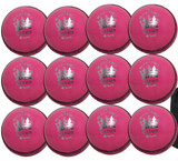 Twelve pink Martin Berrill Sports MBS Supreme Crown balls are arranged in rows like practice cricket balls, with a black ball bag from the 12 Pack With Ball Bag set placed to the right.