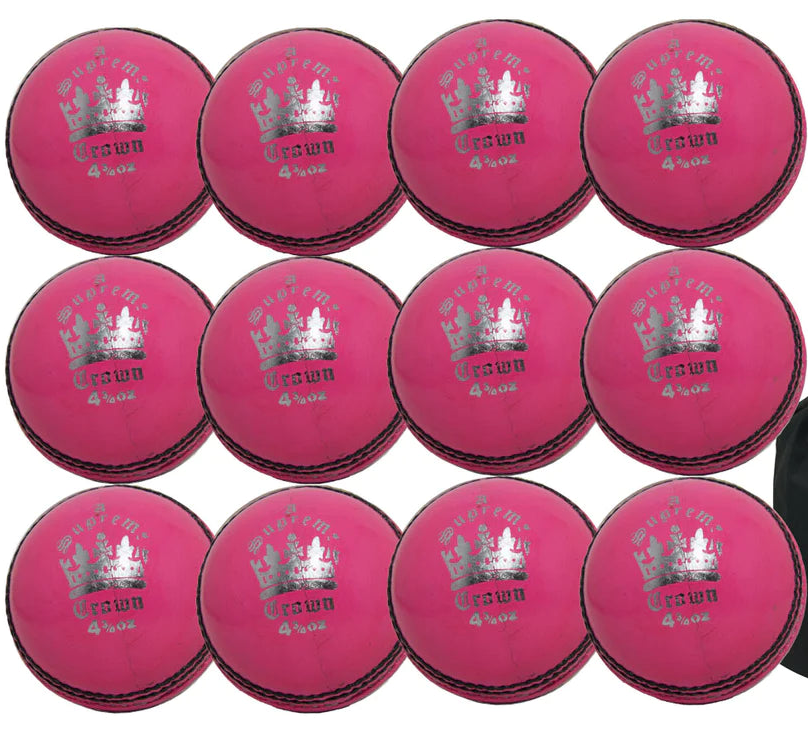 Twelve pink Martin Berrill Sports MBS Supreme Crown balls are arranged in rows like practice cricket balls, with a black ball bag from the 12 Pack With Ball Bag set placed to the right.