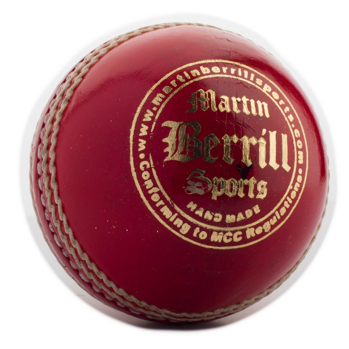 A close-up of the MBS Supreme Crown Cricket Ball, handcrafted from leather with prominent white stitching and gold Martin Berrill Sports branding, plus additional writing along the top edge.