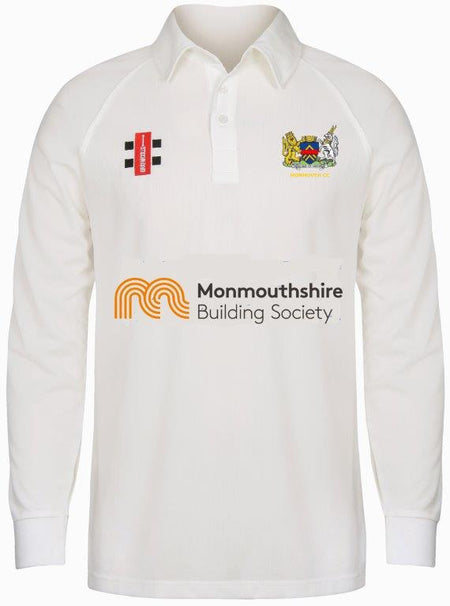 The Gray Nicolls Monmouth CC Junior Larger Sizes Matrix V2 Long Sleeve Shirt is a white cricket shirt featuring the Monmouthshire Building Society logo, colorful club crest, two sponsor logos, and moisture-wicking fabric with collar and buttoned placket.